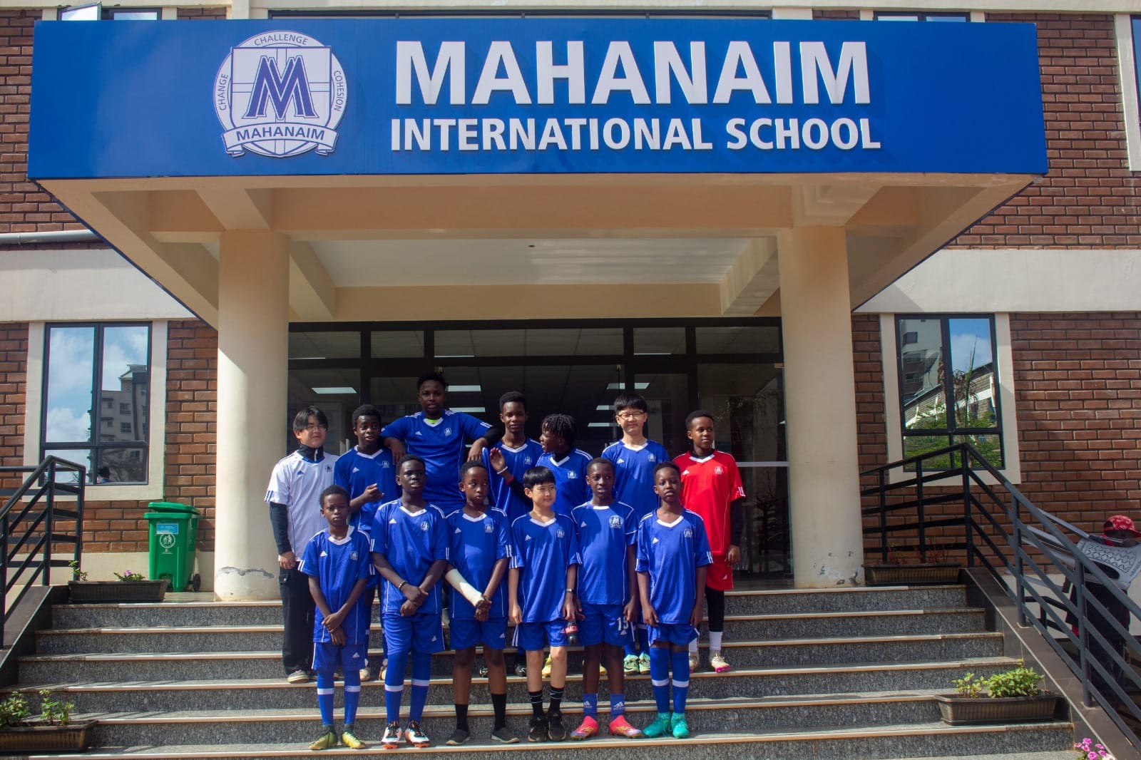 Mahanaim Soccer Academy team at school entrance